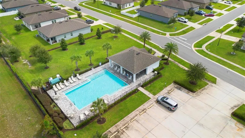 Large community pool and resident lounge chairs and tables for added luxury and convenience.