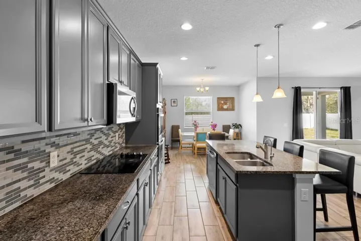 upgraded backsplash to cabinets, Spacious and tons of counterspace.