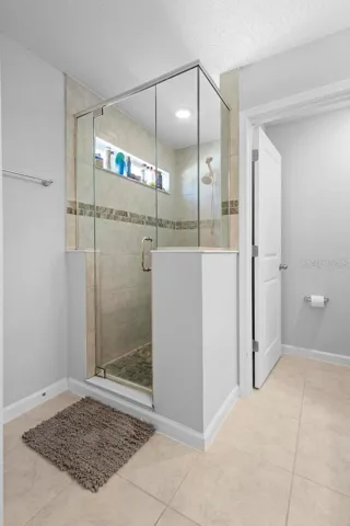 Walk in shower with natural private window to enjoy the morning sun or evening stars while you shower with upgraded glass encasement and tile to ceiling.