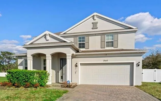 Front elevation. Grand entrance, paved driveway with 2 car garage and front porch.
