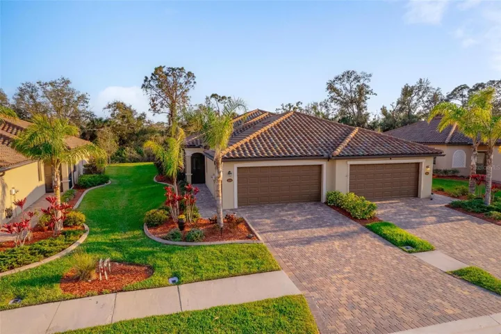 Paver driveway, curbed flower beds, gutters all around