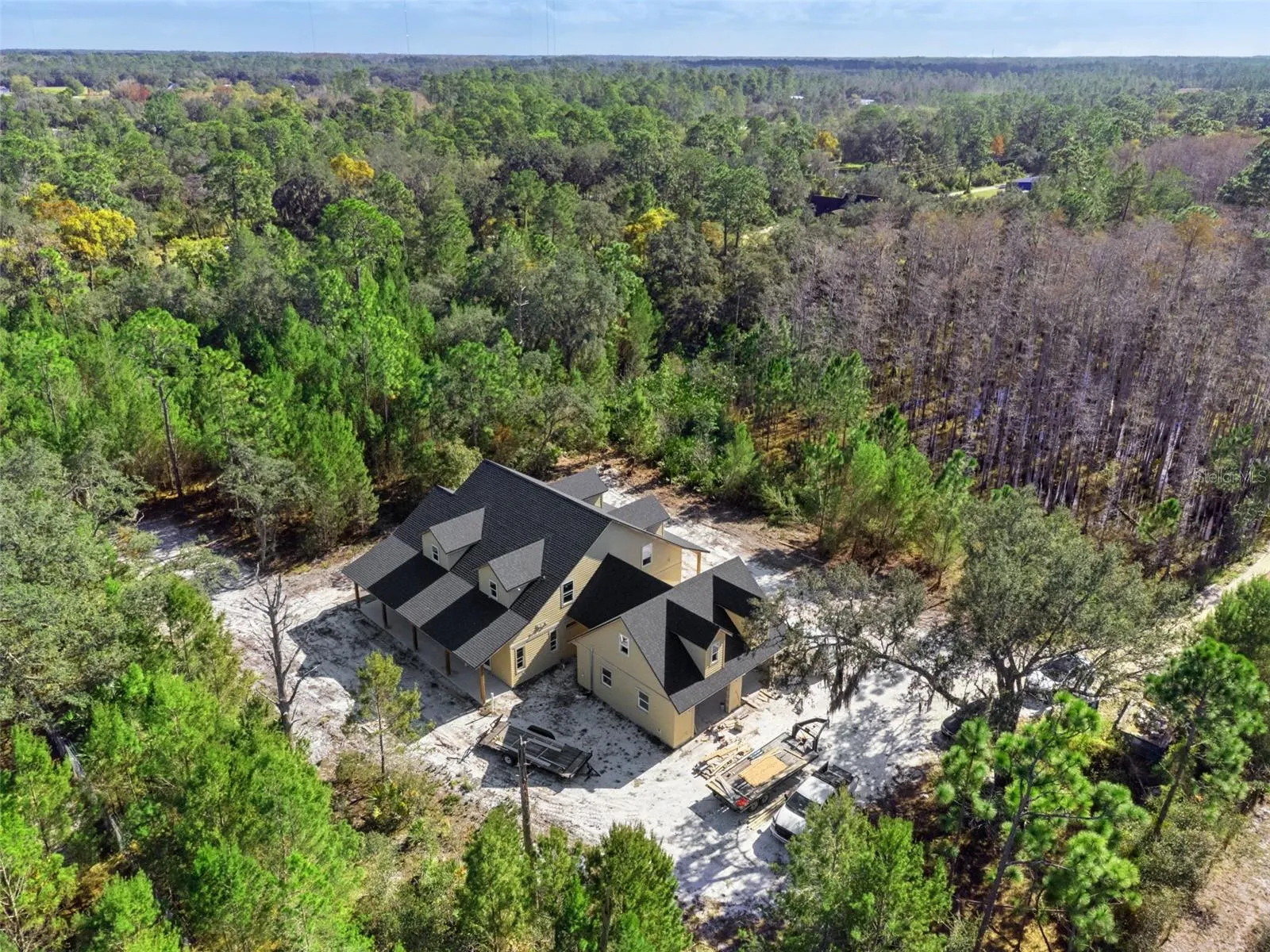 Overhead view of the side of the home with two car detached garage
