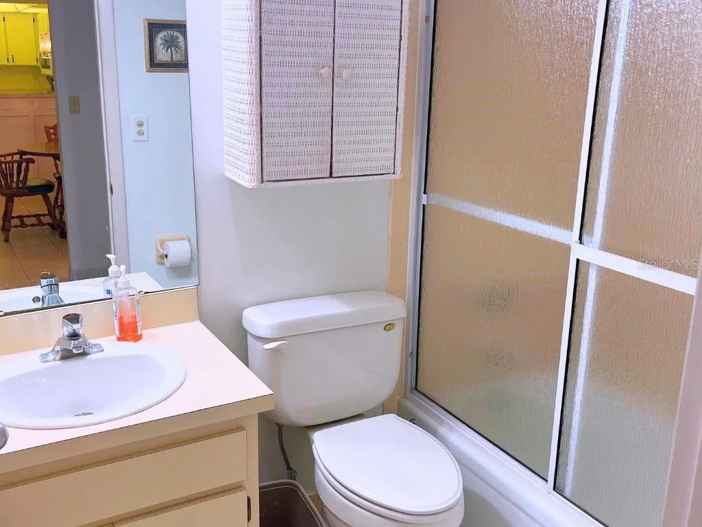 GuestBath_3006CaringWay_PortCharlotte_LightWoodCabinetry.jpg