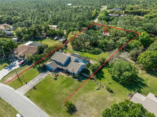Located in Grant-Valkaria, this POOL home on 1.3 ACRES features 3 bedrooms - and BONUS/flex space downstairs complete with its own separate HVAC system that could easily be converted into 4th bedroom/office/in-law suite/guest room/2nd master/additional living area - 2.5 bathrooms, and a detached garage!
