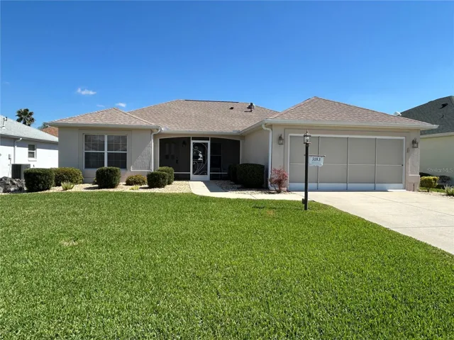 Immaculate curb appeal! Notice the GARAGE Screen and Screened in Front Porch.