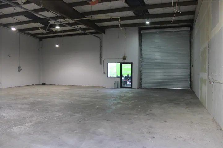 View of front entry and roll-up door