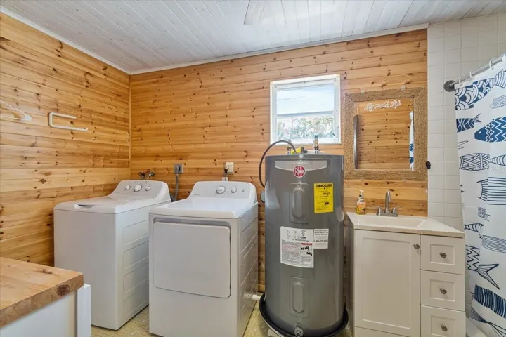 Large utility and laundry area with additional storage.