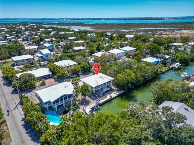 Bird’s-eye view of the property with canal frontage and waterfront setting.