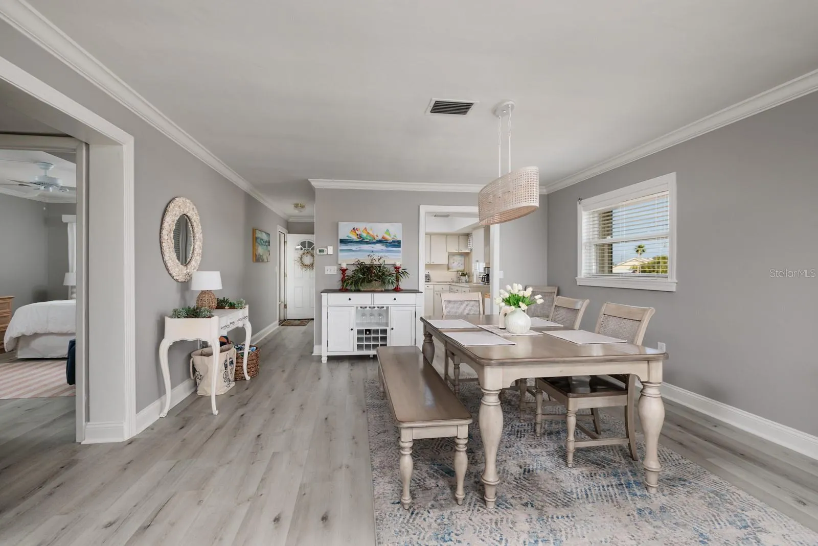 Dining area w/Crown Molding. Doorway to kitchen. 2nd bedroom  on left. Side window w/Hurricane shutter.