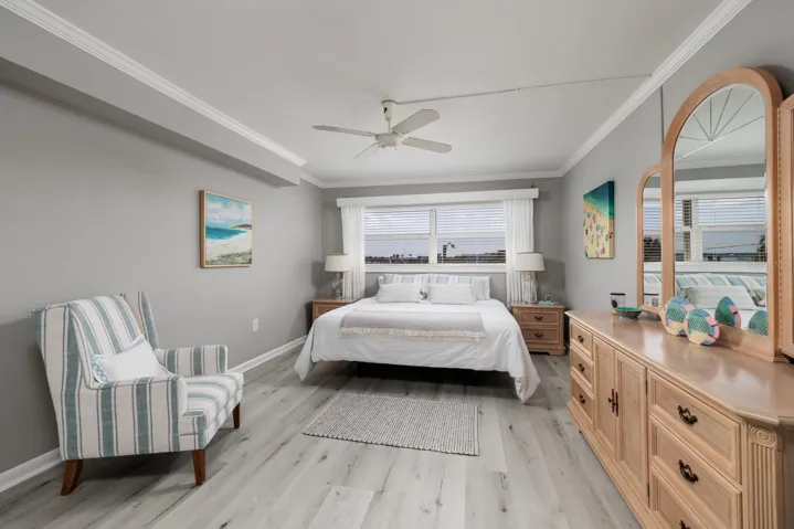 Primary bedroom (12'x16') w/En-suite bath. Crown molding. Window w/Hurricane shutter. Split bedrooms on opposite ends of condo.