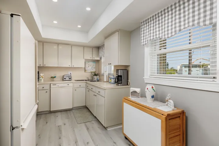 Kitchen w/Dinette area, tray ceiling & 2 windows w/Hurricane shutters.