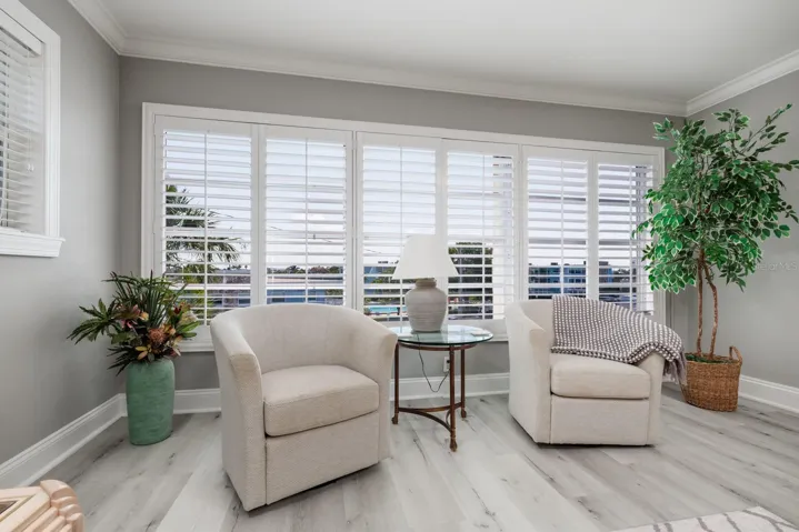 Large living room window w/pool & bay views. Plantation shutters. Window faces southeast. Hurricane Shutter.