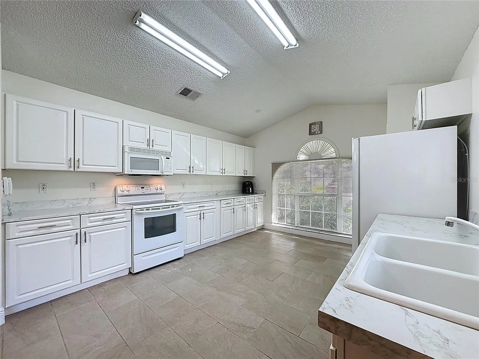 Kitchen has a large front window