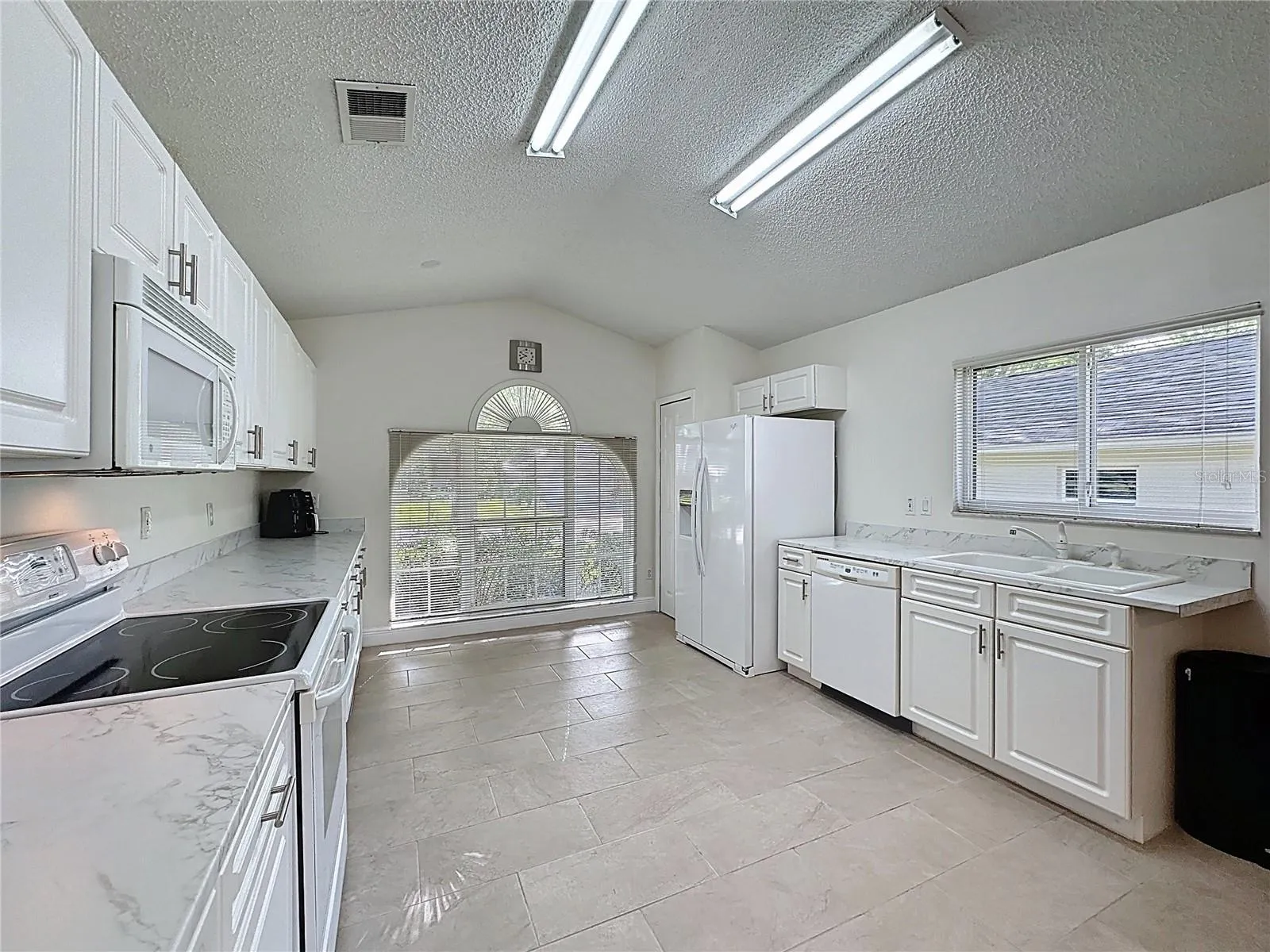 Lots of cabinetry and new flooring throughout the hom