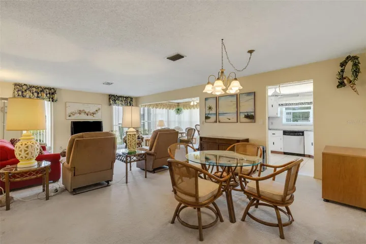 Entry to Unit With Dining area Living Room and Kitchen and Florida Room in Background