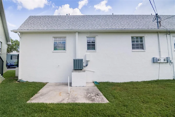 Back of the condo shows the 10x20 ft patio with umbrella stand
