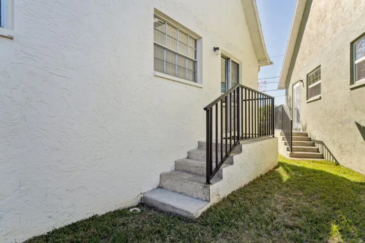 The side stairs leading to the kitchen have a sturdy railing.
