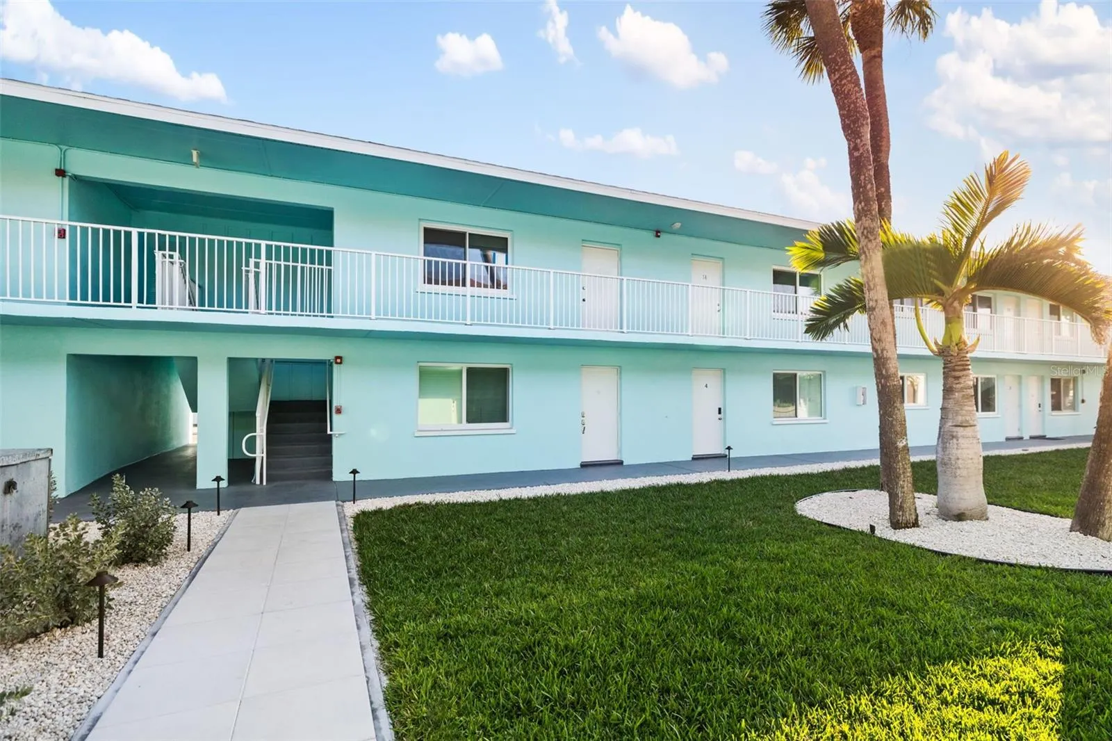 Well-maintained courtyard with lush landscaping and island-style setting.