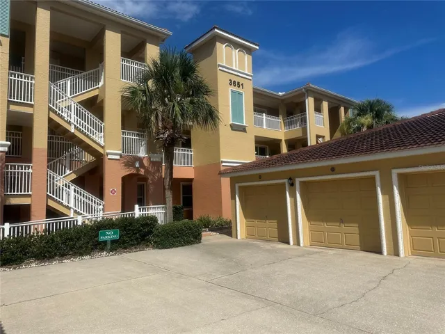 Condo front with garage view
