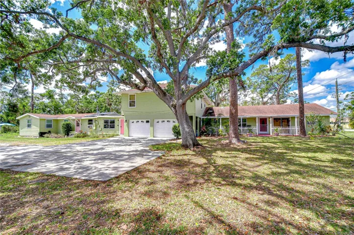The 5 unit complex sits on a very large corner lot. From the front of the building you can see 4 doors. The left most door is our 1/1 long term unit and newly renovated from the studs. The door to the left of the garage is our oversized 1 bedroom apartment known as The Blue Heron. Just over the Garage is our largest 3/2 apartment known as The Palm Apt. To the right of the garage is the magenta walkway leading you into the main area of the house - including access into the Palm Apt and our other 1/1 Lazy Manatee unit which comes with the private front porch. Along the right side of the home is an additional small 1/1 unit known as The Chickadee apt.