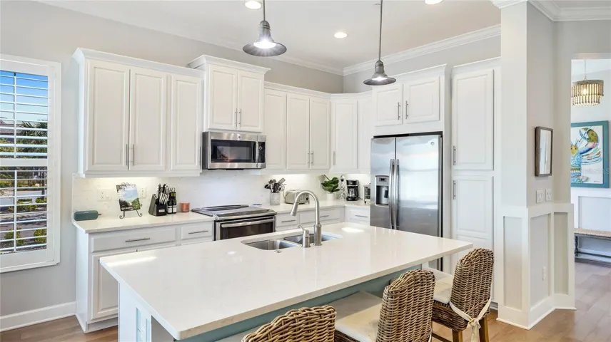 Kitchen Features Stainless Steel Appliances and Island