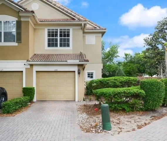 Front of townhouse.  1 car garage.  2-3 parking spaces.  Guest parking is located across the street.