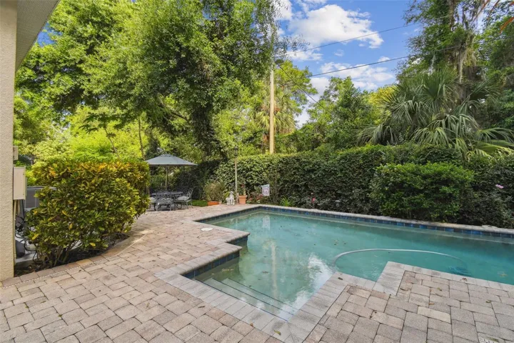 Private and lovely backyard view of the saltwater pool and one of the seating areas.