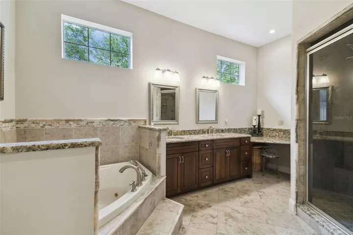Owners bathroom with a jetted tub and walk in shower.