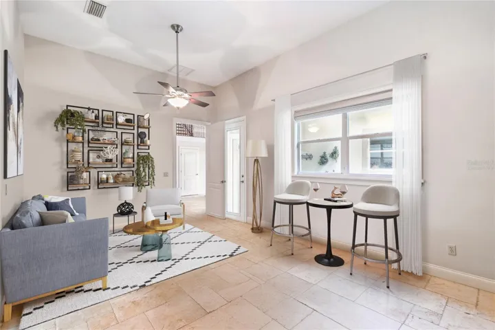 The is another separate wing on the other side of this home that is a perfect space for an in-law, guests that also has a separate entrance and a kitchenette, bedroom and full bath. This room has been virtually staged. The kitchenette is in the next photo.