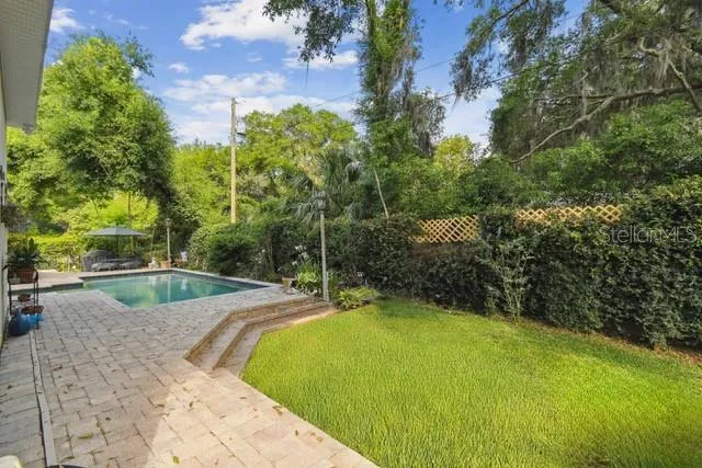 This area can easily become additional backyard green space (currently has pavers).