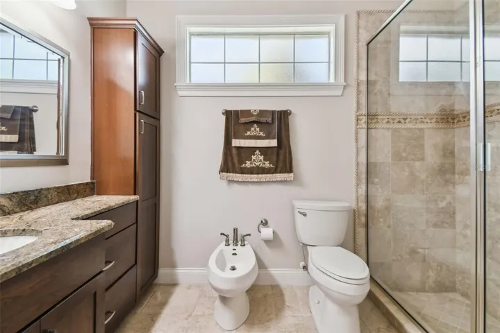 The full bathroom connected to the media and game room with a walk in shower.