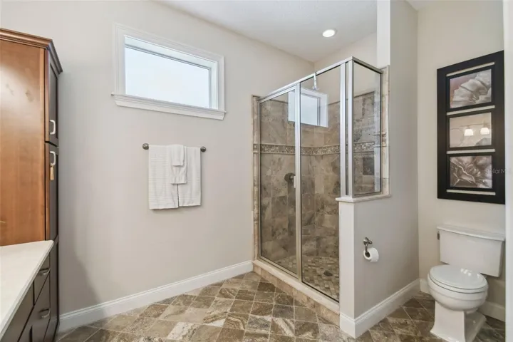 The same bathroom with a walk in shower.