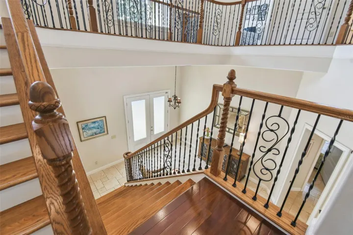 A view from the stairway landing looking to the foyer.