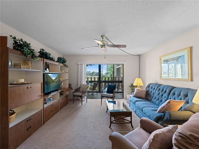 (Virtually Staged) LivingRoom_72BoundaryBlvdUnit226_RotondaWest_LanaiView_Wide.jpg