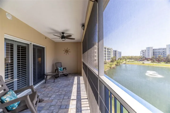 large screen, balcony with tile floors, overlook sparkling pond with fountain