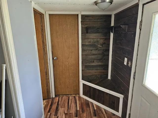Front door foyer leads to bathroom and primary bedroom