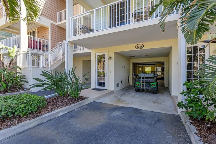 Garage area and parking area for home. Balcony above is off of the kitchen area