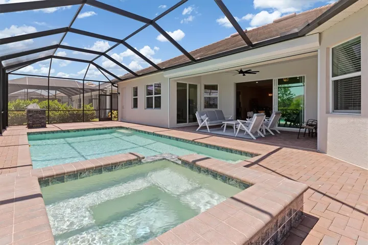 Heated spa connected to pool.