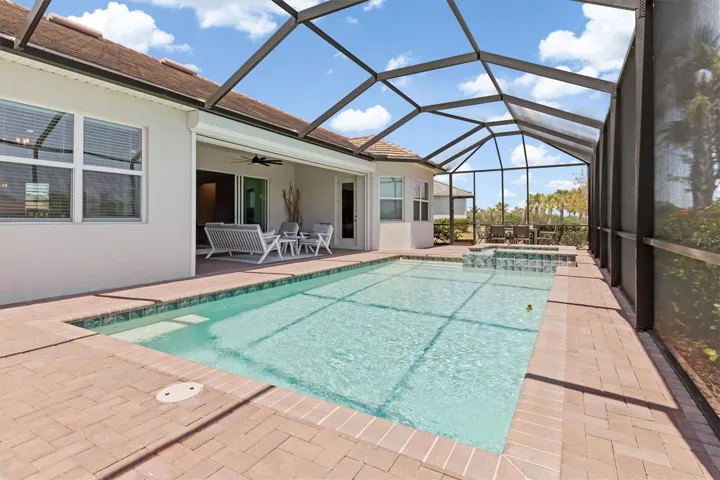 Screened saltwater pool and spa.