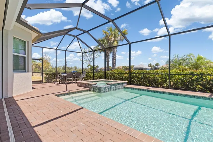 Paver deck and saltwater pool overlooking canal