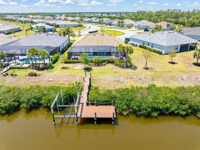 Dock and boat lift directly behind house.
