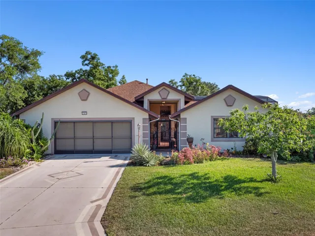 Southwestern accents and lush landscaping are special features of this unique home.