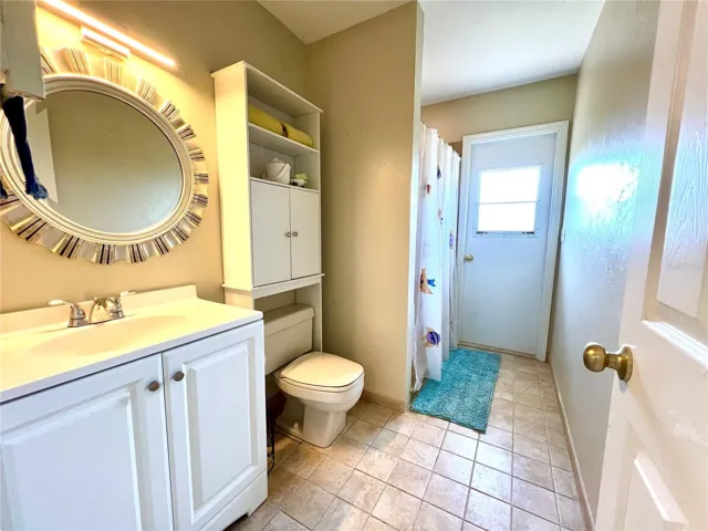 Guest bath, door leading to the wraparound deck