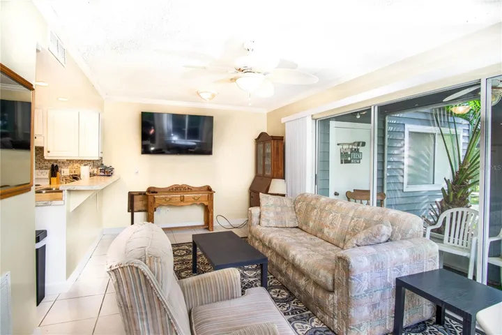 This room is completely furnished. You can see the soft light streaming though the full sliders leading out to the river.