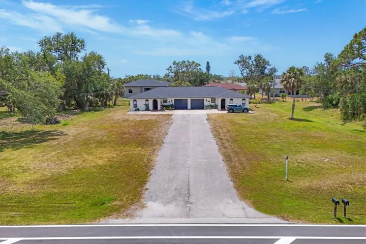 Land on both sides of the driveway to build 2 more duplexes