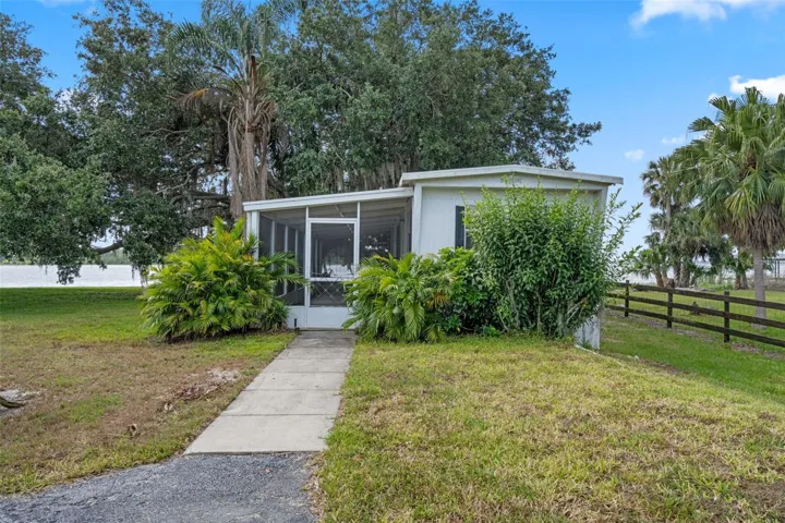 Mobile Home features 2 Bedroom/ 1 Bath and screened-in Front Porch comes turn key ready