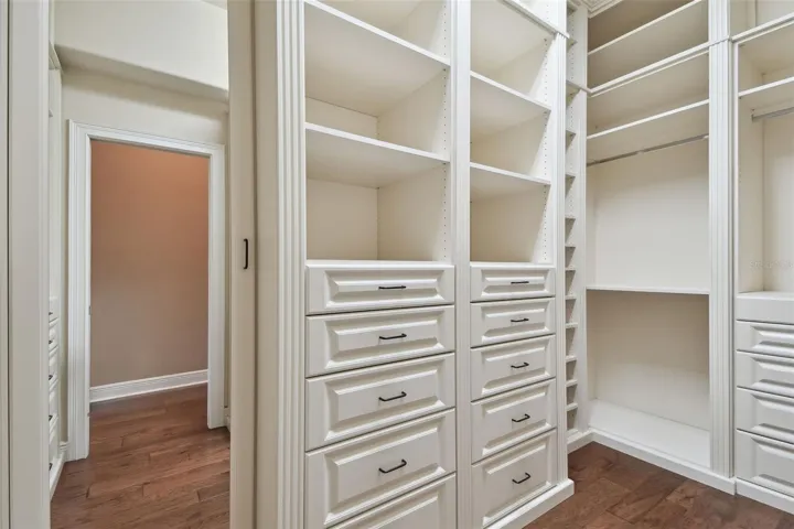 Custom built primary bedroom closet.