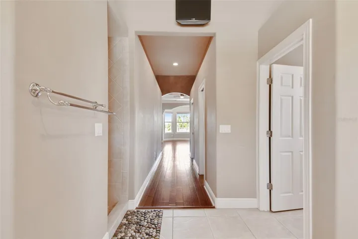 Hallway from the primary bathroom to the primary bedroom.