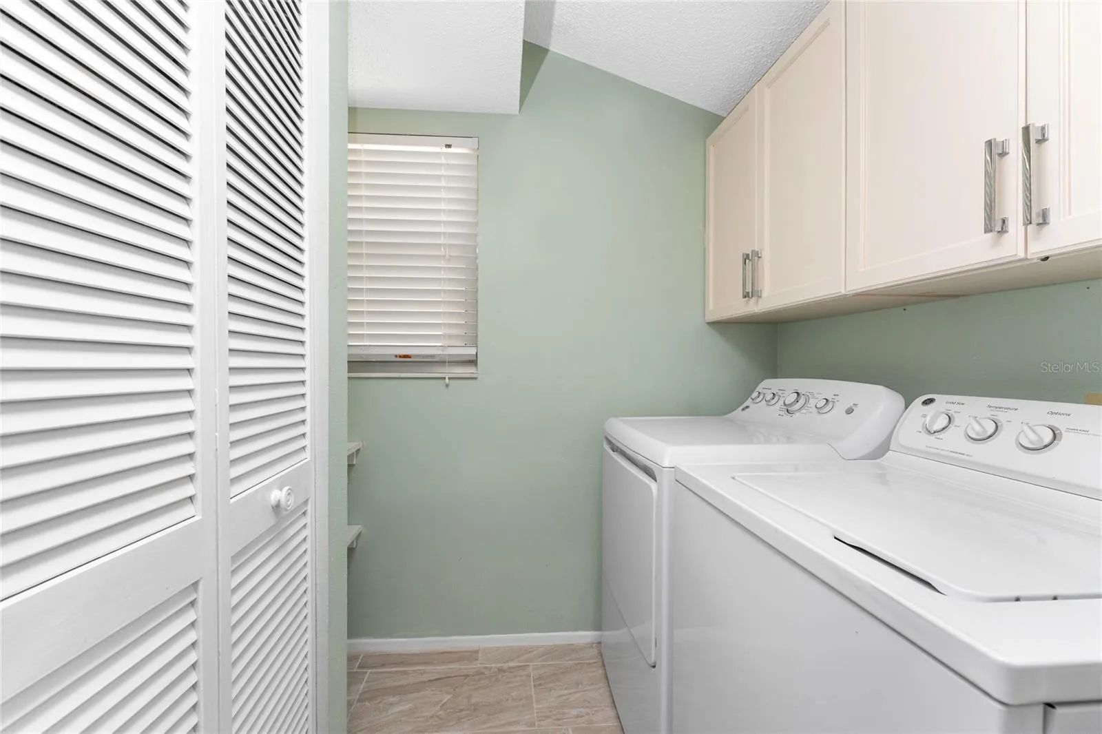Laundry room has a full size GE washer/dryer