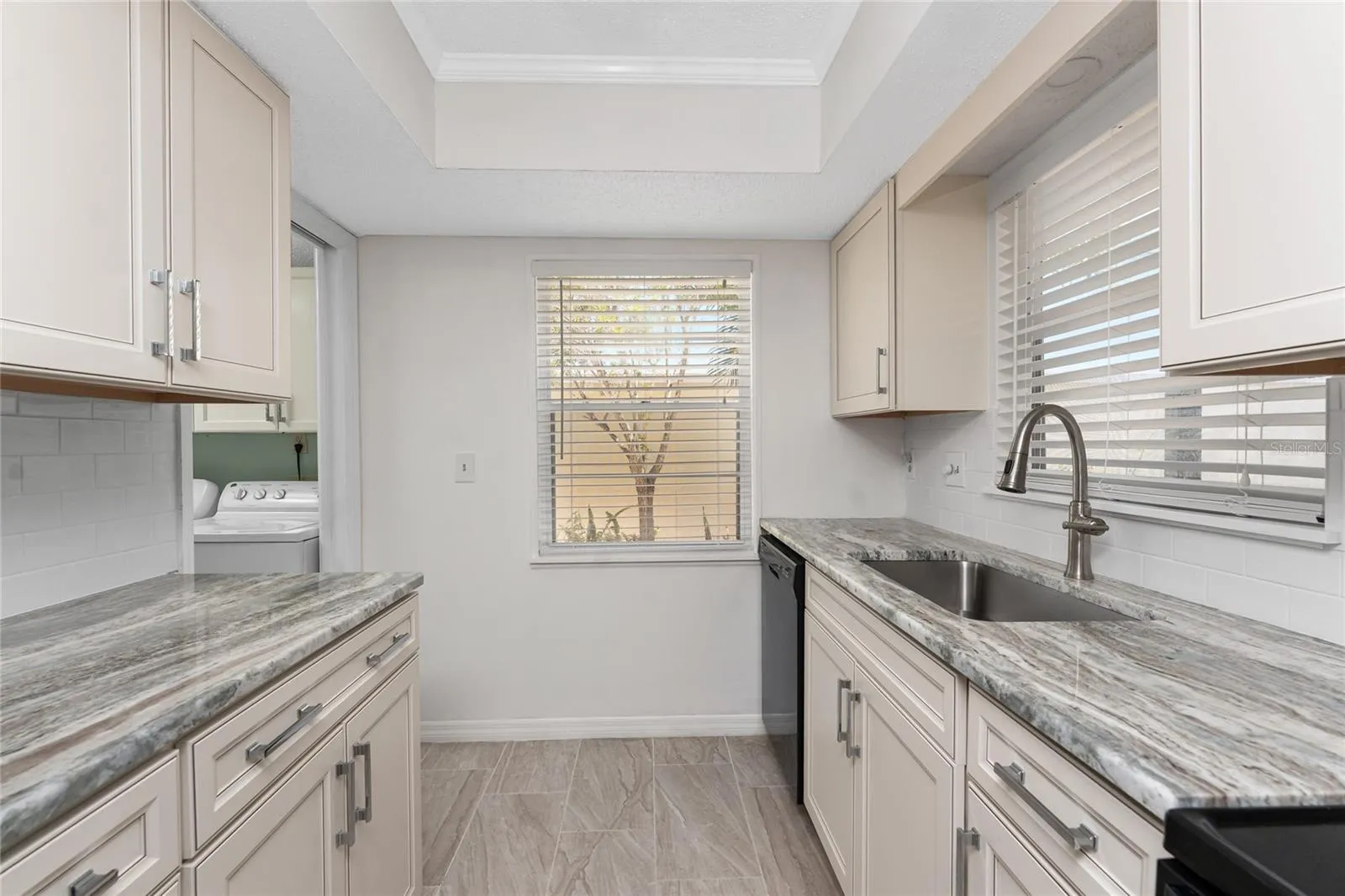 Kitchen has very stylish raised face cabinetry and granite countertops